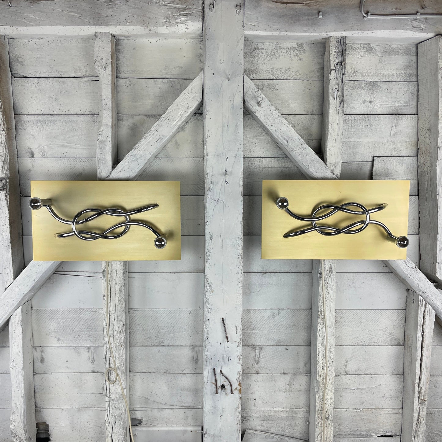 A Pair of 1970s Mid Century Modern Italian 'Reef Knot' Wall Light Panels / Sconces designed by Giacomo Benevelli for Missaglia